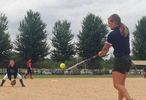 Annie Fleming hits ground balls to her players before a game