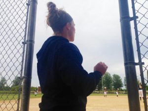 Annie Fleming directs her team from the dugout